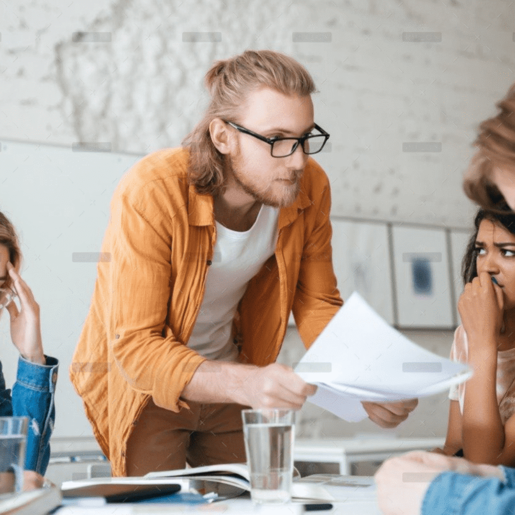 demo-attachment-292-group-of-upset-students-sitting-at-the-table-with-E5YW9L4